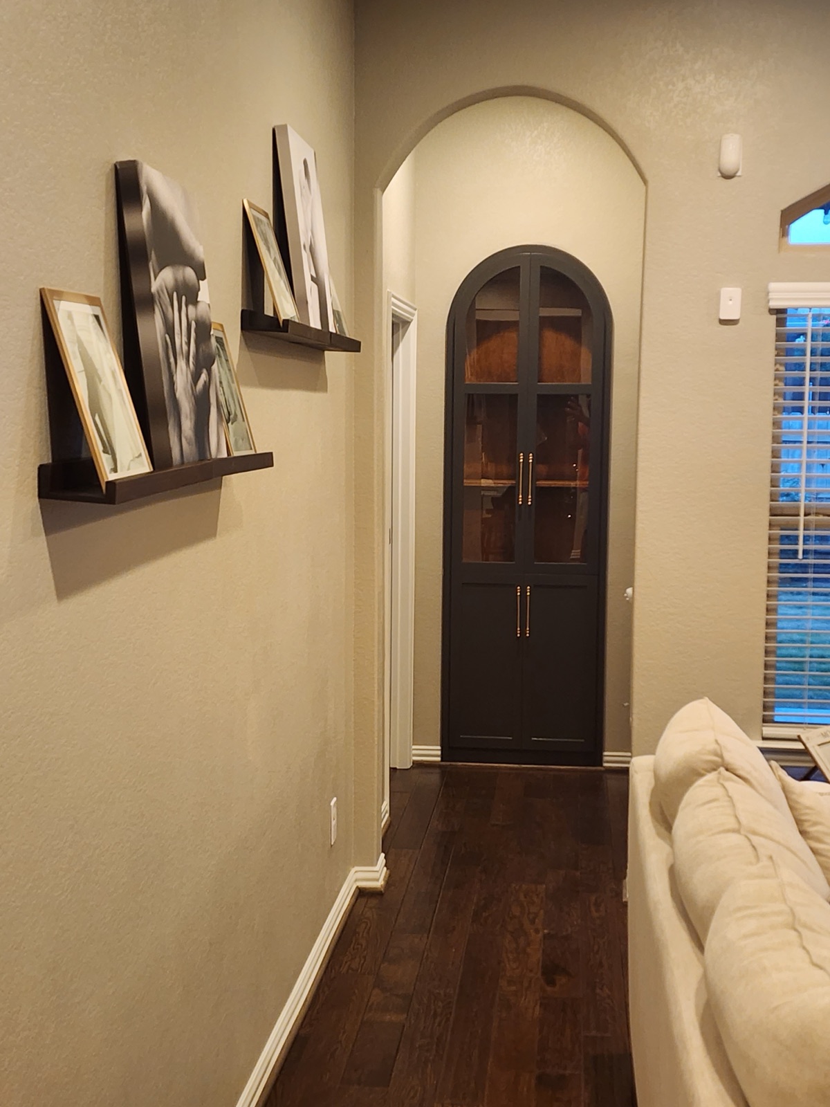 Architectural arched built-in cabinet set into a living-space wall