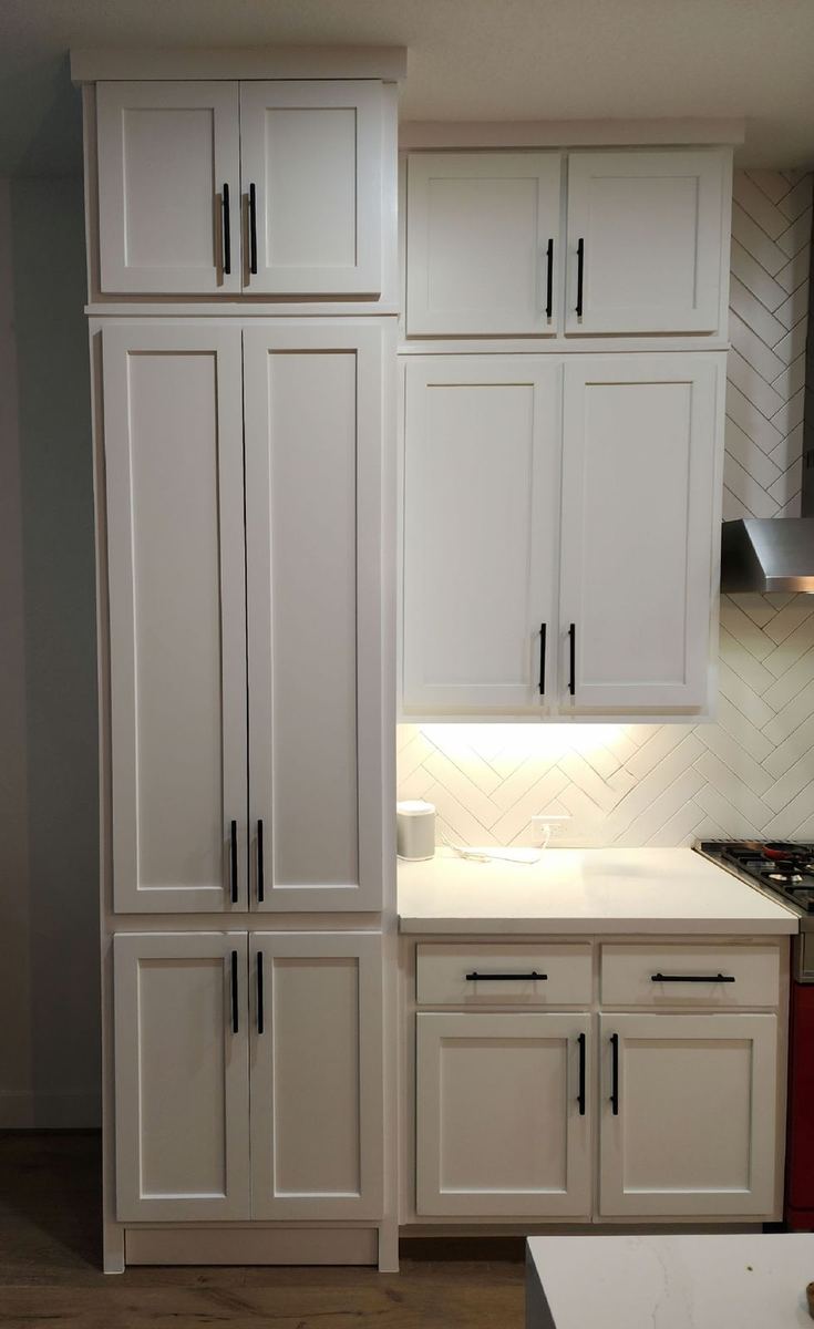 Custom kitchen cabinetry with stained walnut and marble surfaces
