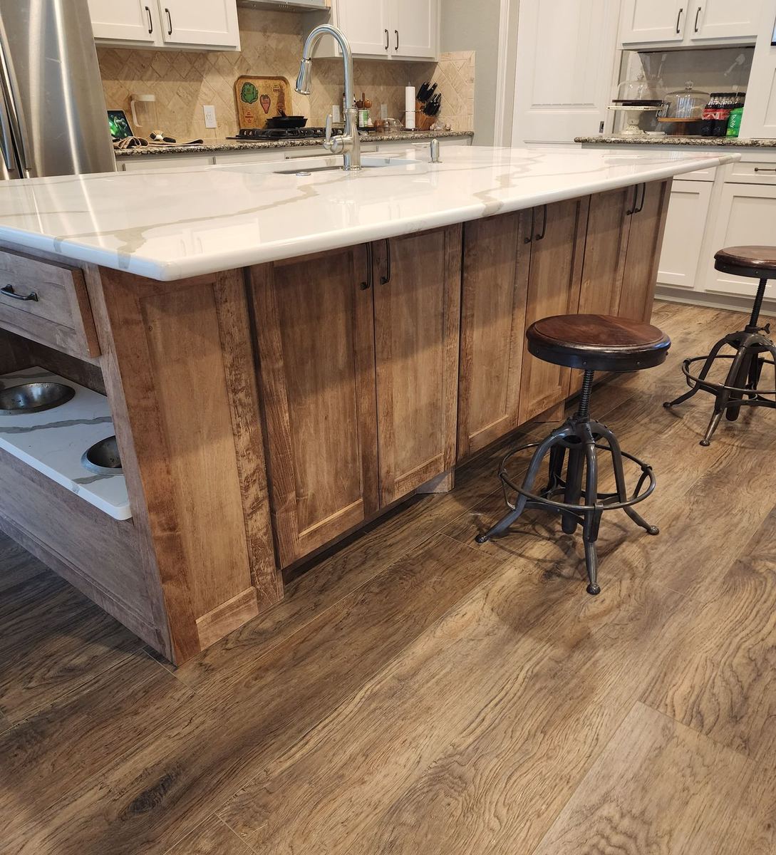 Bespoke kitchen with paneled cabinetry and integrated appliances