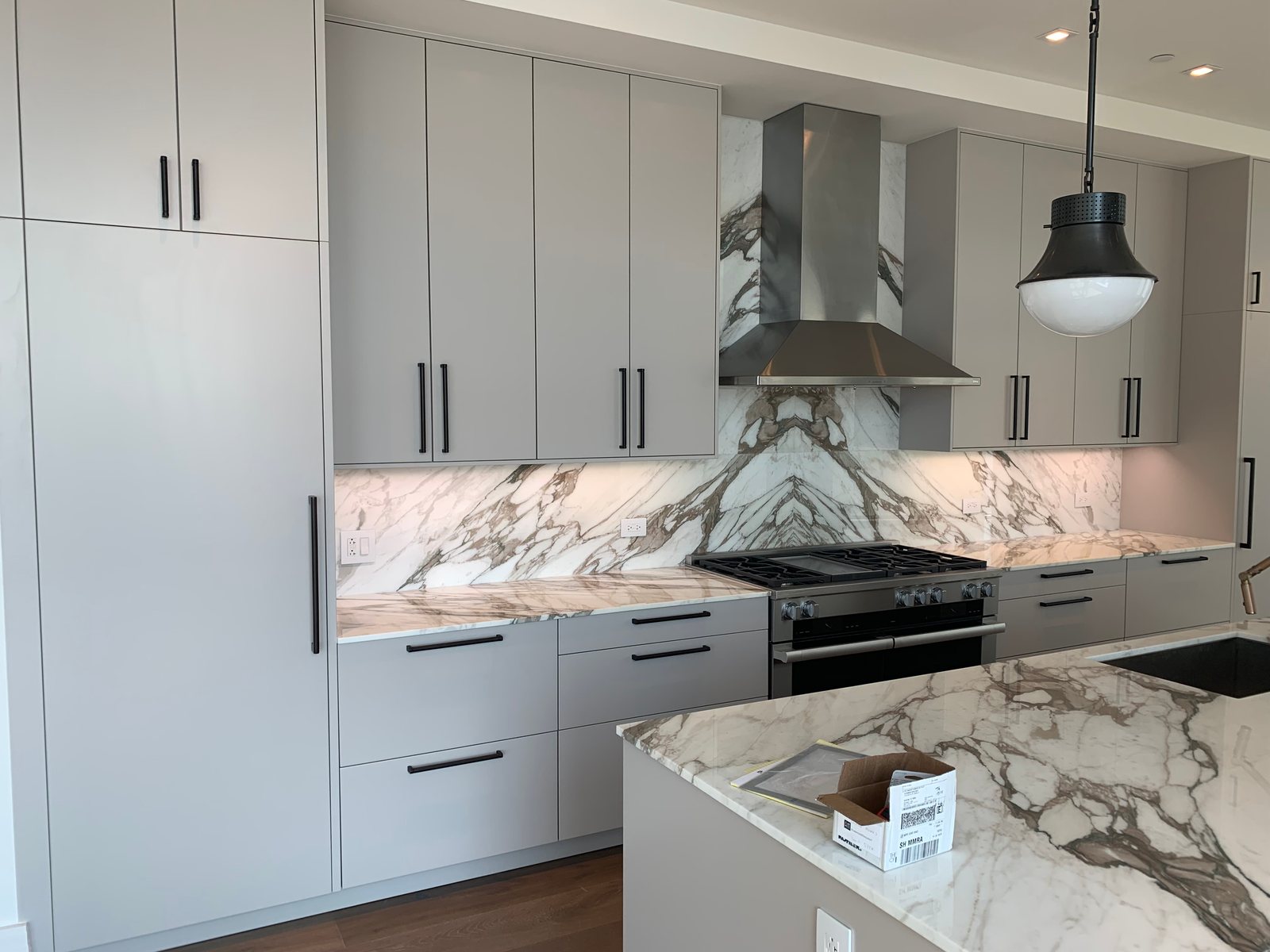 Custom kitchen cabinetry with paneled appliances and coordinated stone surfaces